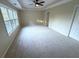 Large bedroom with neutral carpet, ceiling fan, tray ceilings and lots of natural light at 310 Bloomfield Ct, Roswell, GA 30075