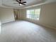 Spacious bedroom featuring a ceiling fan, neutral carpet, and a large window at 310 Bloomfield Ct, Roswell, GA 30075