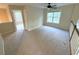 Bright bonus room with neutral carpet, ceiling fan, and natural light streaming through a large window at 310 Bloomfield Ct, Roswell, GA 30075