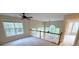 Sun-filled bonus room overlooking backyard, featuring neutral carpet, ceiling fan, and white railing at 310 Bloomfield Ct, Roswell, GA 30075