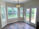 Sunny dining area with large windows and French doors leading to the backyard at 310 Bloomfield Ct, Roswell, GA 30075