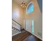 Bright foyer with soaring ceilings, elegant chandelier, and beautiful wood floors with white trim staircase at 310 Bloomfield Ct, Roswell, GA 30075