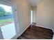 Hallway with dark wood floors leading to the backyard at 310 Bloomfield Ct, Roswell, GA 30075