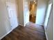Hallway with wood floors leading to kitchen at 310 Bloomfield Ct, Roswell, GA 30075