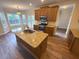 Modern kitchen features a granite island, stainless steel appliances, and wood cabinets at 310 Bloomfield Ct, Roswell, GA 30075