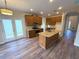 Well-lit kitchen featuring wood cabinets, granite countertops, and a stainless steel range with access to the backyard at 310 Bloomfield Ct, Roswell, GA 30075
