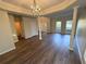 Bright living room with hardwood floors, classic columns, and a decorative chandelier, with great flow to other spaces at 310 Bloomfield Ct, Roswell, GA 30075