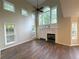 Bright living room featuring a fireplace, lots of windows, and dark wood floors at 310 Bloomfield Ct, Roswell, GA 30075