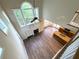 Open-concept living space with fireplace, kitchen island, hardwood floors, and lots of natural light at 310 Bloomfield Ct, Roswell, GA 30075