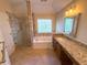 Bathroom featuring a walk-in shower, soaker tub, granite countertops, and warm lighting at 310 Bloomfield Ct, Roswell, GA 30075