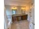 Bathroom with double vanity, granite countertops, tiled floors, and garden tub at 310 Bloomfield Ct, Roswell, GA 30075
