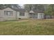 Exterior view of a home featuring light-colored siding and double hung windows, and large grassy area in the front at 4064 Sunset Dr, Atlanta, GA 30331