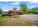 View of the home featuring an attached garage and a spacious driveway at 110 Otelia Ln, Covington, GA 30014