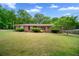 Charming brick home featuring lush landscaping and a well-manicured front yard at 110 Otelia Ln, Covington, GA 30014