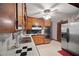 Efficient kitchen with stainless steel appliances, tile countertops, and wooden cabinetry at 110 Otelia Ln, Covington, GA 30014