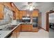 Well-equipped kitchen with updated appliances, wood cabinets and checkered backsplash at 110 Otelia Ln, Covington, GA 30014