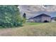Large grassy backyard with mature trees offering privacy, great for outdoor activities at 245 Brickstone Pkwy, Covington, GA 30016