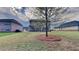 Grassy backyard featuring a tree in the middle and views of surrounding homes at 245 Brickstone Pkwy, Covington, GA 30016