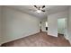Cozy bedroom featuring plush carpet, neutral walls, closet, and ensuite bathroom at 245 Brickstone Pkwy, Covington, GA 30016