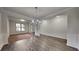 Elegant dining room with hardwood floors, chandelier, and decorative molding for gatherings at 245 Brickstone Pkwy, Covington, GA 30016