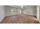 Expansive main bedroom features a tray ceiling with fan and ample space for furniture at 245 Brickstone Pkwy, Covington, GA 30016