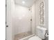 Well-lit bathroom with a tiled walk-in shower, decorative wall art and modern fixtures offering a clean, stylish design at 2490 Turtle Ter, Grayson, GA 30017