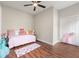Bright bedroom featuring hardwood floors, ceiling fan, and charming decor at 2490 Turtle Ter, Grayson, GA 30017