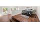 Comfortable bedroom showcasing warm wood floors, modern decor, with a stylish bed and ample natural light at 2490 Turtle Ter, Grayson, GA 30017