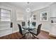 Bright dining area with a glass table, modern chandelier, and plenty of natural light at 2490 Turtle Ter, Grayson, GA 30017