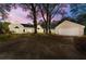 Charming single-story home with a large driveway and well-maintained lawn at dusk at 2490 Turtle Ter, Grayson, GA 30017