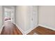 A bright hallway features hard wood floors and white trim that provide a modern and clean aesthetic at 2490 Turtle Ter, Grayson, GA 30017