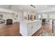 Open concept kitchen featuring a spacious island, stainless steel appliances, and hardwood flooring at 2490 Turtle Ter, Grayson, GA 30017