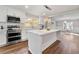 Bright kitchen with stainless steel appliances, a center island, and hardwood floors at 2490 Turtle Ter, Grayson, GA 30017