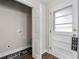 A bright laundry area features a laundry closet, wooden floors, and a white door to the exterior at 2490 Turtle Ter, Grayson, GA 30017