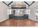 An open living room features hardwood floors, and a black stone feature with stairs leading to another room at 2490 Turtle Ter, Grayson, GA 30017