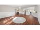 Open-concept living area with hardwood floors and seamless flow to the kitchen and dining at 2490 Turtle Ter, Grayson, GA 30017