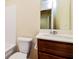 Functional bathroom featuring a wood vanity, sink, mirror, and a toilet at 507 Highwood Ln, Atlanta, GA 30344