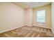 Cozy bedroom with neutral walls, carpet, and a window providing natural light at 507 Highwood Ln, Atlanta, GA 30344