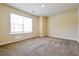 Bright bedroom with neutral carpet, a large window, and freshly painted walls at 507 Highwood Ln, Atlanta, GA 30344
