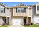 Charming townhome featuring a one-car garage, well-maintained landscaping, and neutral siding at 507 Highwood Ln, Atlanta, GA 30344