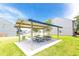 Outdoor picnic area with tables under a shaded pavilion on the lawn at 507 Highwood Ln, Atlanta, GA 30344