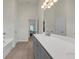 Bathroom featuring a double sink vanity with a grey cabinet, white countertops and tile floors at 571 Hancock Se Dr, Atlanta, GA 30354