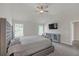 Bedroom with high ceilings, a large bed, carpet, and a TV at 571 Hancock Se Dr, Atlanta, GA 30354