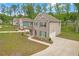 Charming two-story home with a brick facade, attached garage, manicured lawn and extended driveway at 571 Hancock Se Dr, Atlanta, GA 30354
