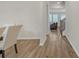 Bright hallway with hardwood floors leading to a living room with abundant natural light from multiple windows at 571 Hancock Se Dr, Atlanta, GA 30354