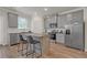 Well-lit kitchen featuring stainless steel appliances, a kitchen island, and grey cabinets at 571 Hancock Se Dr, Atlanta, GA 30354