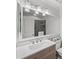 Bright bathroom with a stylish vanity, large mirror, and a glimpse of the tiled shower at 6900 Roswell Rd # J2, Atlanta, GA 30328