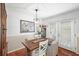 Elegant dining area featuring a modern table and chairs, complemented by natural light from the french doors at 6900 Roswell Rd # J2, Atlanta, GA 30328