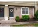 Charming townhome exterior with a decorative wreath, well-maintained lawn, and a welcoming entrance at 6900 Roswell Rd # J2, Atlanta, GA 30328