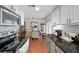 Modern kitchen showcasing granite countertops, stainless steel appliances, and a seamless connection to the dining area at 6900 Roswell Rd # J2, Atlanta, GA 30328